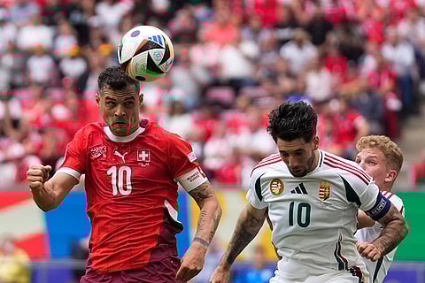 Granit Xhaka and Dominik Szoboszlai challenge for the ball